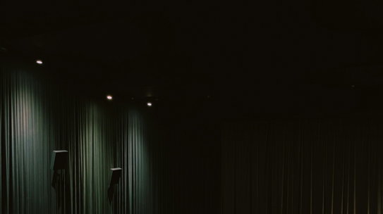 a row of chairs sitting in front of a theater screen